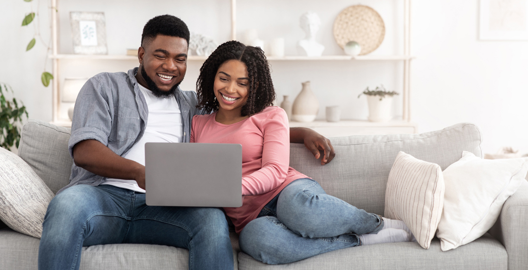 couple on couch with laptop