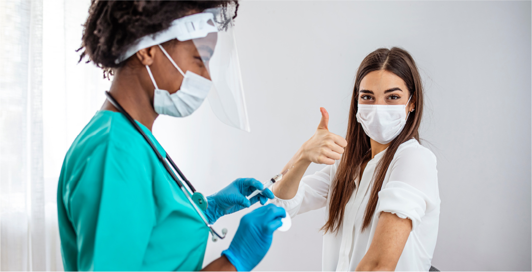 Thumbs up women getting a vaccination