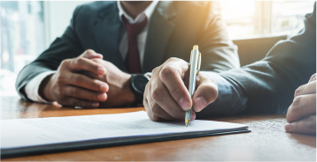 Someone signing a contract