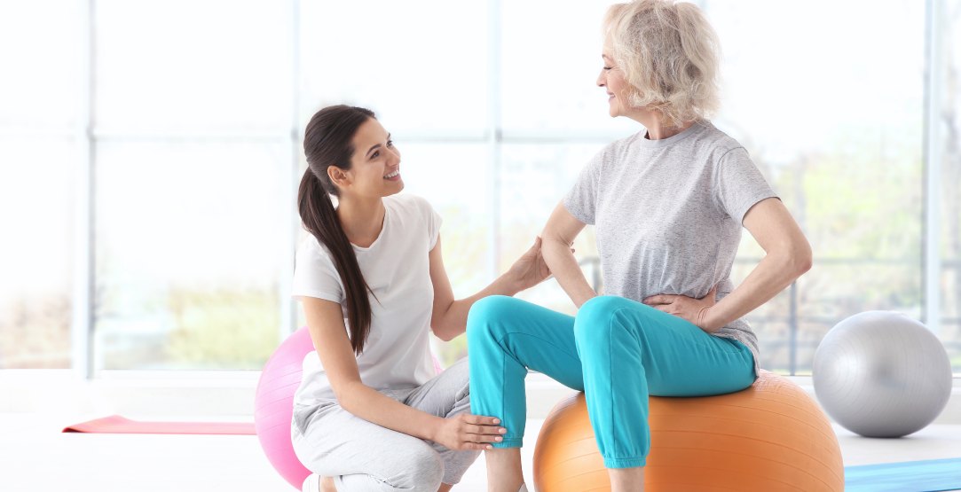Elderly woman doing strengthening exercises on a yoga ball