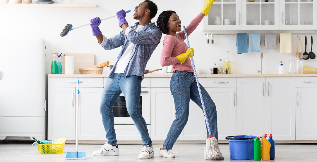 African couple having fun cleaning