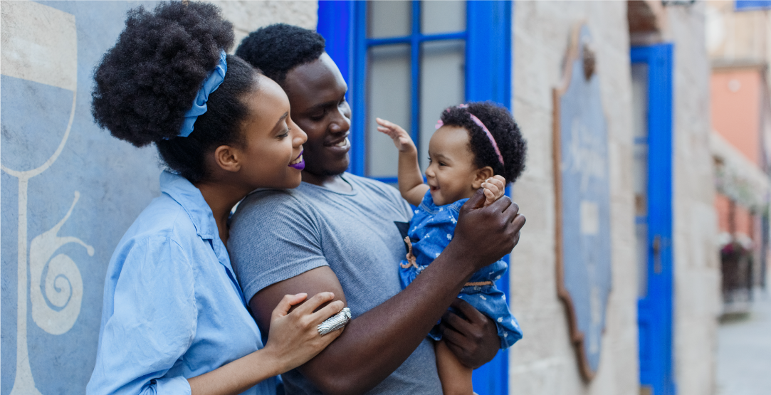 African family entertaining their baby