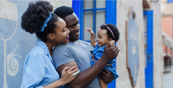 African family entertaining their baby